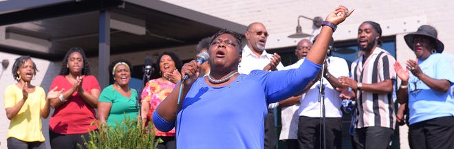 Unity Park held its grand opening on downtown Greenville's west side, Thursday morning, May 19, 2022. Members of the West End Community Choir sing during the grand opening ceremony.