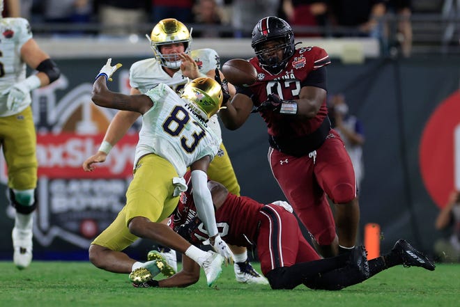 South Carolina Gamecocks defensive lineman Nick Barrett (93) picks off a fumble from Notre Dame Fighting Irish wide receiver Jayden Thomas (83) during the third quarter of the TaxSlayer Gator Bowl of an NCAA college football game Friday, Dec. 30, 2022 at TIAA Bank Field in Jacksonville. The Notre Dame Fighting Irish held off the South Carolina Gamecocks 45-38. [Corey Perrine/Florida Times-Union]