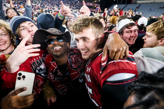 Nov 19, 2022; Columbia, South Carolina, USA; South Carolina Gamecocks linebacker Colin Bryant (45) celebrates with students on the field after defeating the Tennessee Volunteers at Williams-Brice Stadium. Mandatory Credit: Jeff Blake-USA TODAY Sports